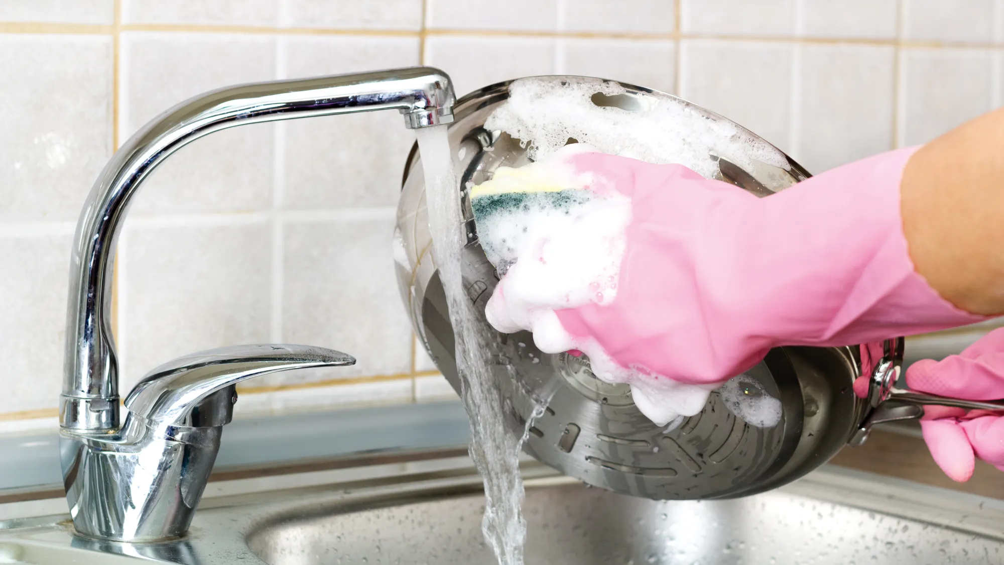 A person scrubbing a pan